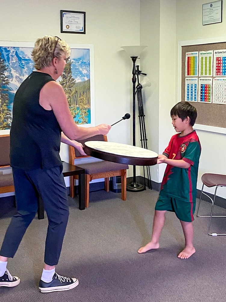Everest and Beth in an Neurologic Music Therapy session
