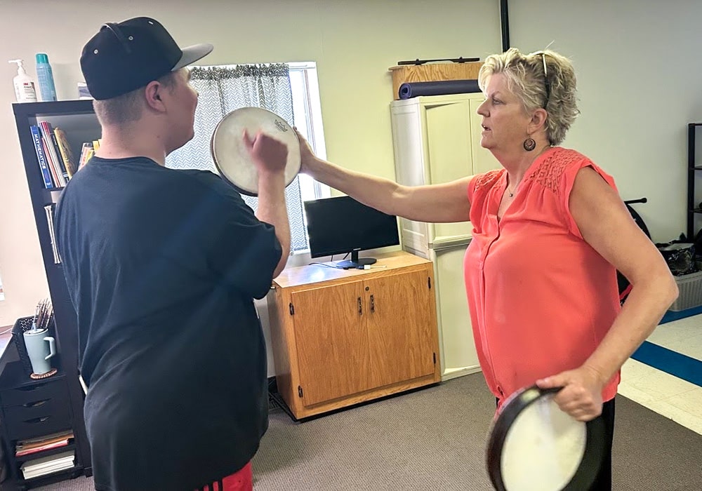 Beth Susag and Josiah working on Rhythm during Neurologic Music Therapy